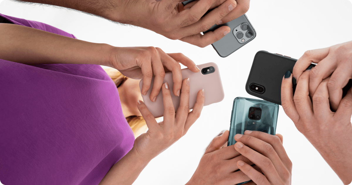 Four people holding iPhones and Android phones