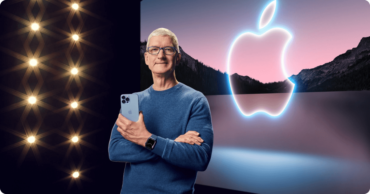 Tim Cook standing on a stage at an Apple event in front of the Apple logo