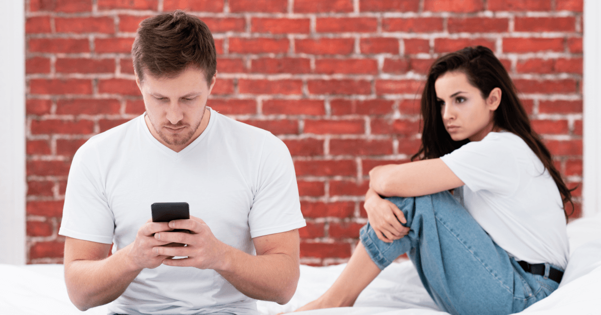 Man on phone ignoring girlfriend