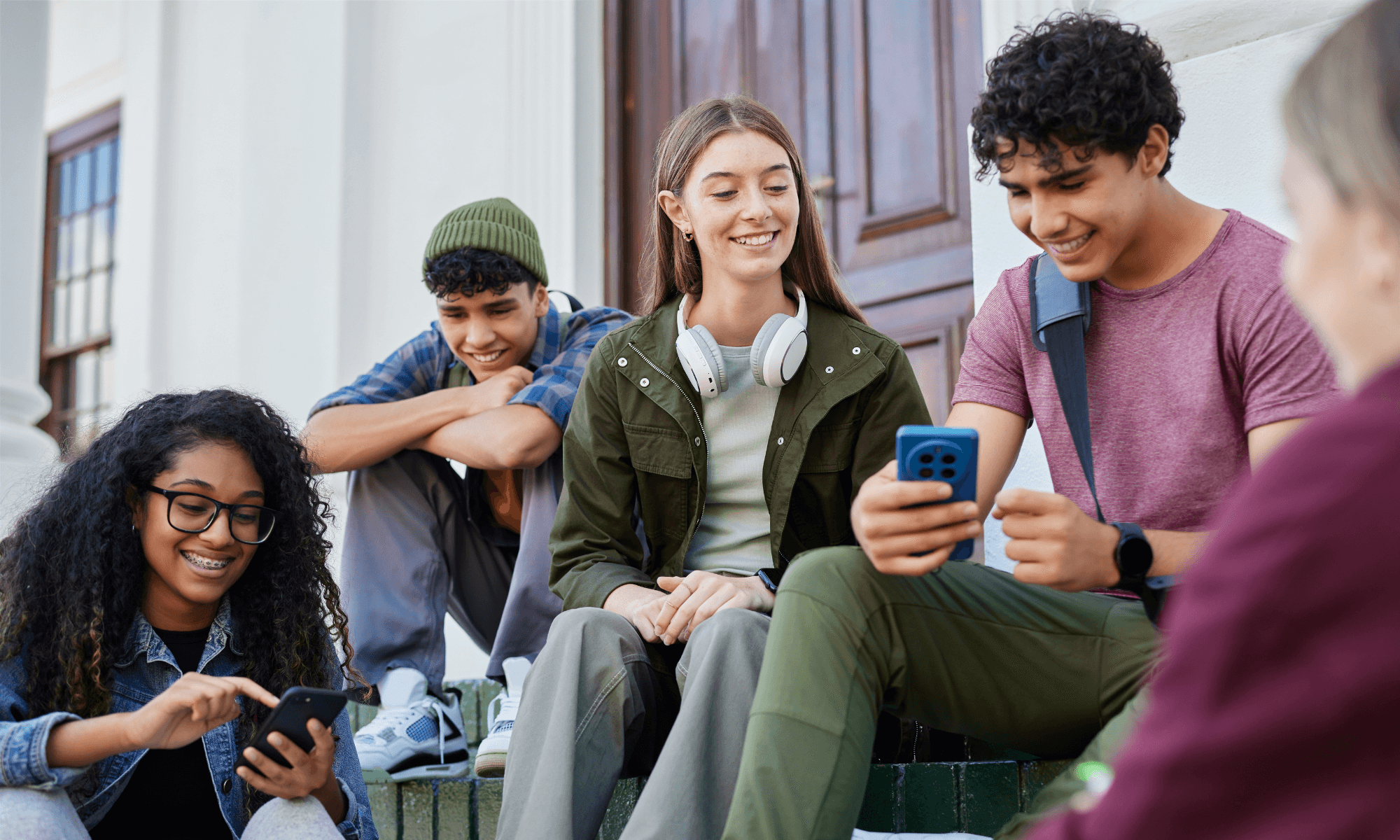 College students socialising on campus with their phones out.